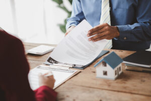 Real estate contract signing illustrating California Statute of Frauds requirements for written property agreements.